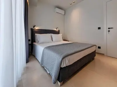 a bedroom with a large bed in a room at AKTI city apartment in Rhodes Town