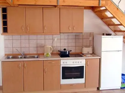 a kitchen with a stove and a sink and a refrigerator at Lakis Apartments in Faliraki