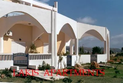 a white building with arches on the side of it at Lakis Apartments in Faliraki