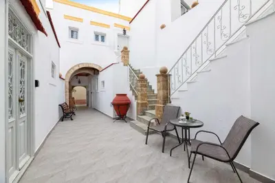 a hallway with stairs and a table and chairs at Casa Tradizionale in Rhodes Town