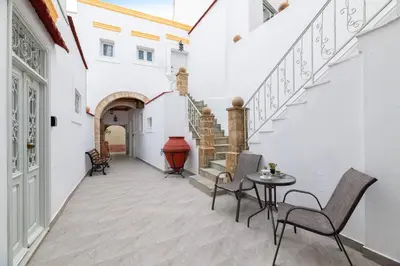 a hallway with stairs and a table and chairs at Casa Tradizionale in Rhodes Town