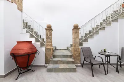 a staircase with a red vase and a table at Casa Tradizionale in Rhodes Town