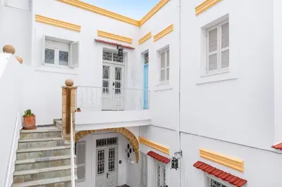 a white house with stairs and a balcony at Casa Tradizionale in Rhodes Town