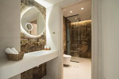 a bathroom with a sink and a mirror at Sirin Luxury Suites Groundfloor in Haraki