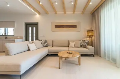 a living room with a couch and a table at Sirin Luxury Suites Groundfloor in Haraki