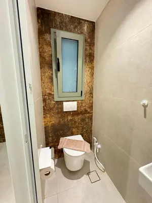 a bathroom with a toilet and a sink and a mirror at Sirin Luxury Suites Groundfloor in Haraki