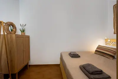 a bedroom with a bed with two towels on it at Lemon Tree Symi in Symi