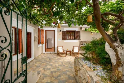 a courtyard in a house with a tree at Lemon Tree Symi in Symi
