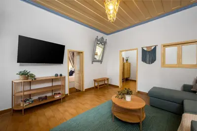 a living room with a couch and a tv at Lemon Tree Symi in Symi