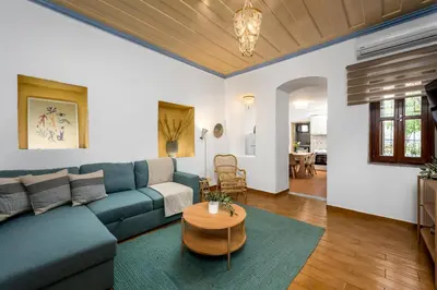 a living room with a blue couch and a table at Lemon Tree Symi in Symi