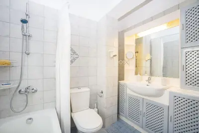 a white bathroom with a toilet and a sink at Family Getaway Home in Rhodes Town
