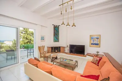 a living room with a couch and a tv at Family Getaway Home in Rhodes Town