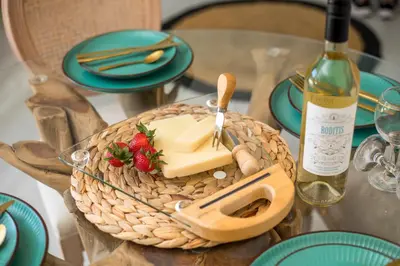 a table with a basket of cheese and a bottle of wine at Lady Stamatias House in Halki