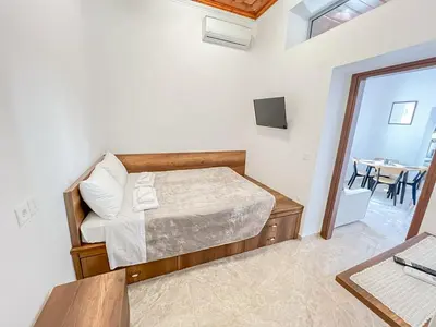 a small bedroom with a bed and a table at La Casa di villagio in Koskinou