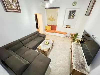 a living room with a couch and a table at La Casa di villagio in Koskinou