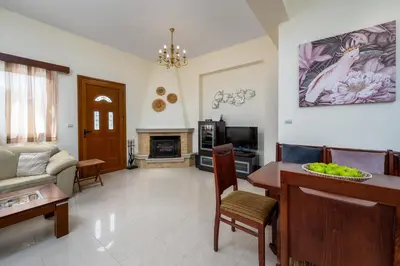 a living room with a couch and a table at Hermes' Getaway Plimmiri in Plimmiri