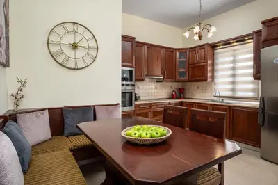 a kitchen with a table with a bowl of apples on it at Hermes' Getaway Plimmiri in Plimmiri