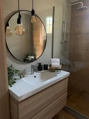 a bathroom with a sink and a mirror at Christos House in Afantou