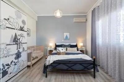 a bedroom with a bed and a crib in it at Christos House in Afantou