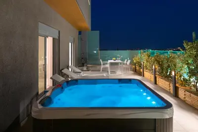 a hot tub on the balcony of a house at Rhodes SkyLine Suite with out Door Jacuzzi Sea View A1 in Ixia