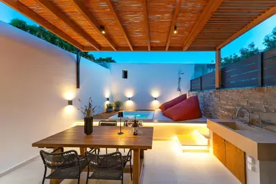 a kitchen and dining area with a table and chairs at Atria luxury experience in Kattavía