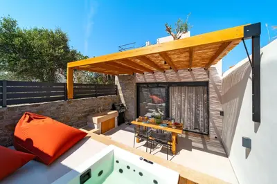 a rooftop patio with a wooden pergola at Atria luxury experience in Kattavía