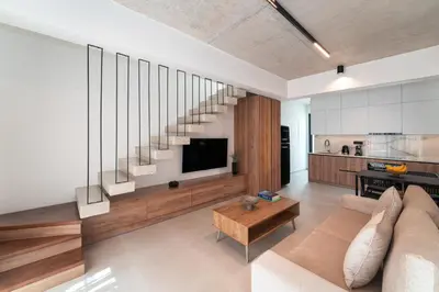 a living room with a couch and a tv and stairs at Atria luxury experience in Kattavía