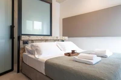a bedroom with a large bed with towels on it at Atria luxury experience in Kattavía