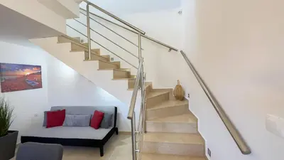 a staircase in a house with a couch under it at Ismini Luxury Villa in vlicha