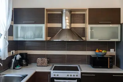 a kitchen with a sink and a stove top oven at Ismini Luxury Villa in vlicha