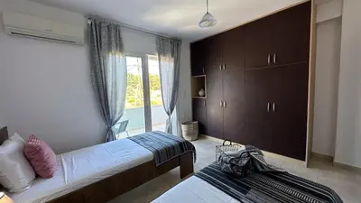 a bedroom with two beds and a window at Ismini Luxury Villa in vlicha