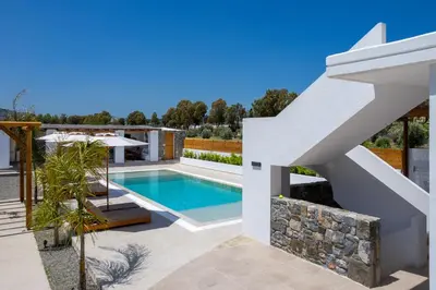 a swimming pool in the backyard of a villa at JOHANNES LUXURY VILLAS in Kolimbia