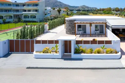 a house with a view of a tennis court at JOHANNES LUXURY VILLAS in Kolimbia