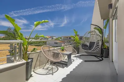 a balcony with chairs and a view of the ocean at Coral Paradise Luxury Modern Family Villa with Jacuzzi, Pool View & Parking in Rhodes Island in Kremasti