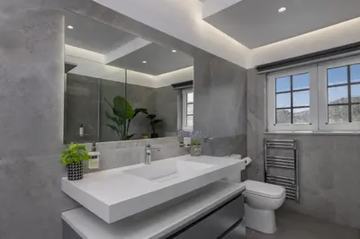 a bathroom with a white sink and a toilet at Coral Paradise Luxury Modern Family Villa with Jacuzzi, Pool View & Parking in Rhodes Island in Kremasti