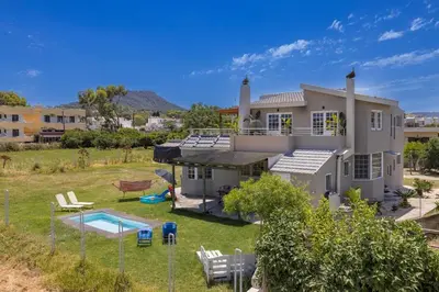 a house with a swimming pool and a yard at Coral Paradise Luxury Modern Family Villa with Jacuzzi, Pool View & Parking in Rhodes Island in Kremasti