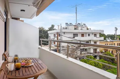 a balcony with a table with a plate of food on it at Casa Di Natalia in Rhodes Town
