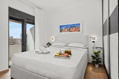 a white bed with a tray of fruit on it at Casa Di Natalia in Rhodes Town