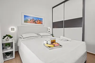 a white bed with a tray of food on it at Casa Di Natalia in Rhodes Town