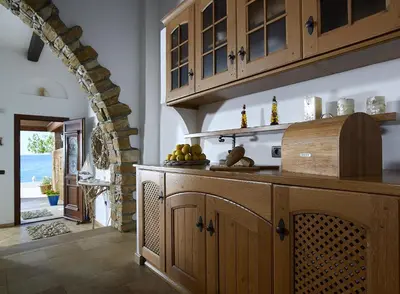 a kitchen with wooden cabinets and a counter top at Villa Haraki Paradise in Haraki