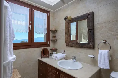 a bathroom with a sink and a mirror at Villa Haraki Paradise in Haraki