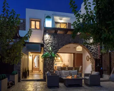 a villa with a living room at night at Villa Haraki Paradise in Haraki