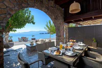 an outdoor dining area with a table with food on it at Villa Haraki Paradise in Haraki