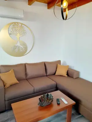 a living room with a brown couch and a table at 