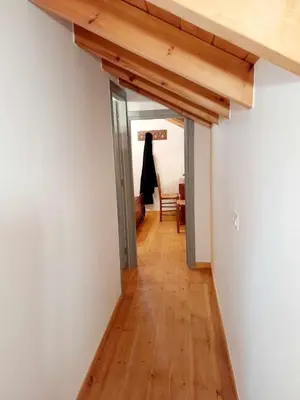 a hallway leading into a room with a wooden floor at 