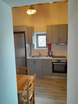 a kitchen with stainless steel appliances and a table at 