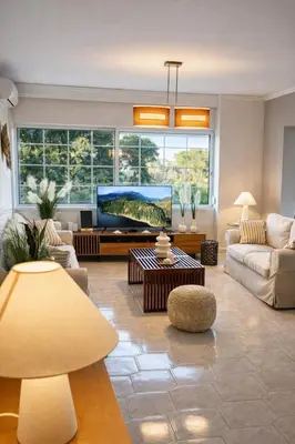 a living room with a large tv and a couch at Erofili's Apartment ONLY 700 meters from the beach in Ialyssos