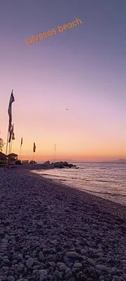 a person is flying a kite on the beach at Erofili's Apartment ONLY 700 meters from the beach in Ialyssos