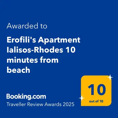 a yellow sign that reads awarded to extinguish apartmentilles niches minutes from at Erofili's Apartment ONLY 700 meters from the beach in Ialyssos