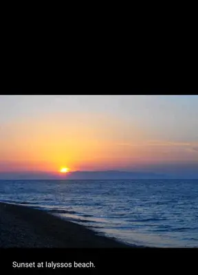 a sunset at the beach with the sun in the horizon at Erofili's Apartment ONLY 700 meters from the beach in Ialyssos